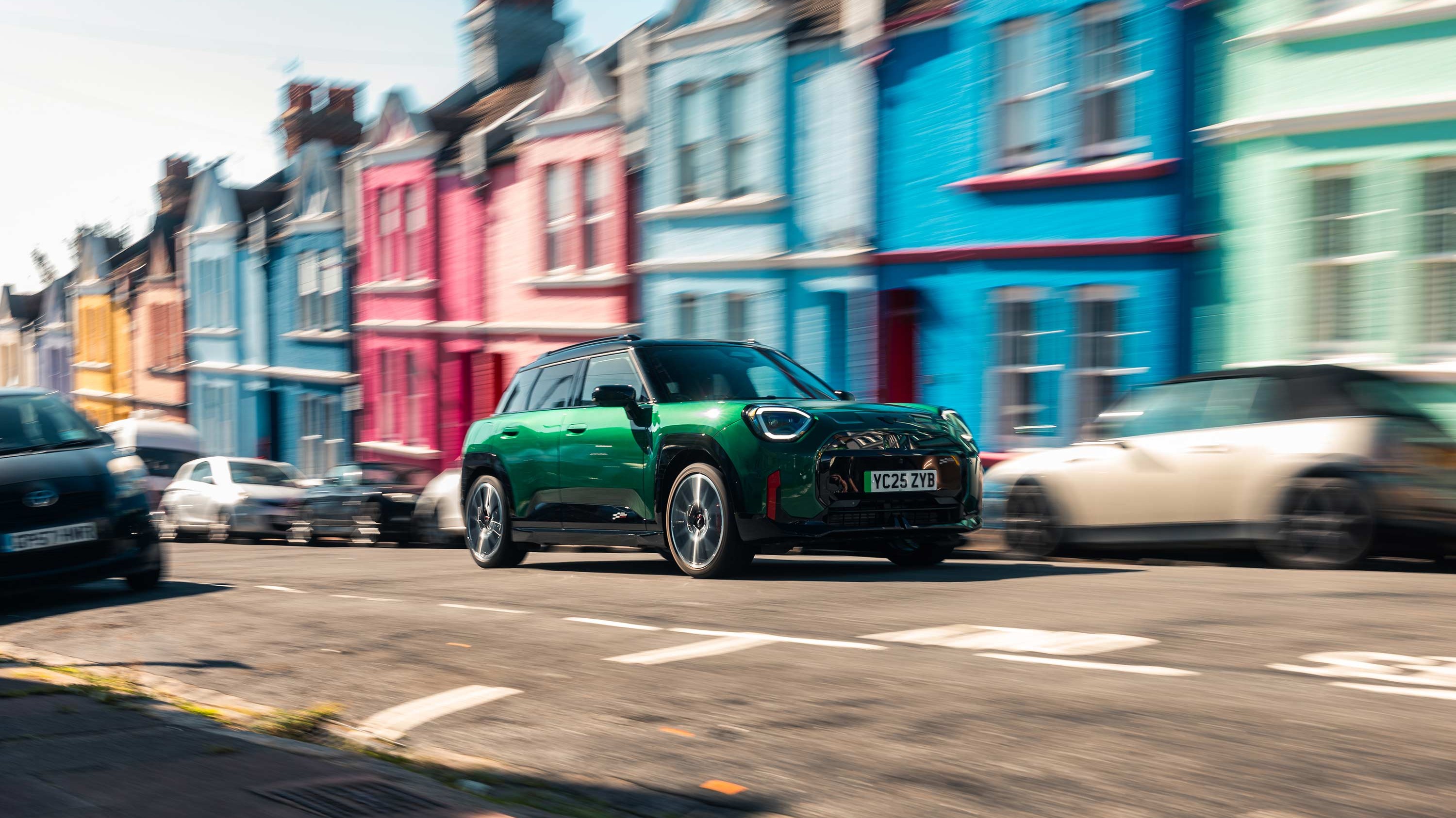 MINI Cooper 5-door driving down the road, past a purple building